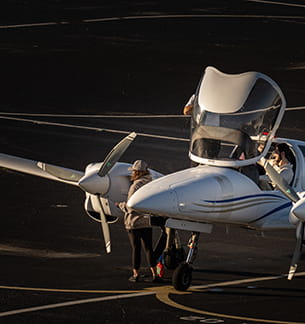 Embry-Riddle students inspect a plane on the tarmac
