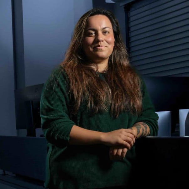 Darcy Cruz stands in a NASA control room