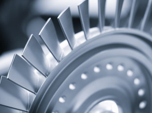 Close-up image of a metallic turbine or engine blade assembly.