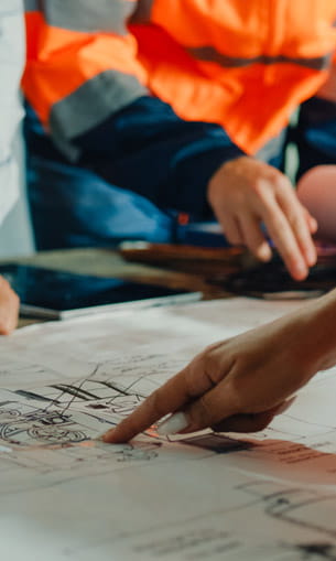 People pointing at a blueprint.