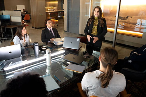 Student and interns working in a business environment