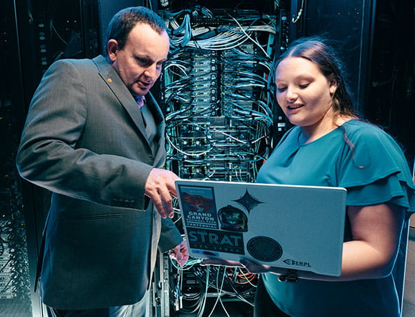 Professor and student working on the CRAY supercomputer