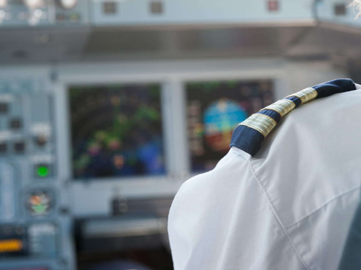 Pilot stripe on a shoulder in a cockpit.