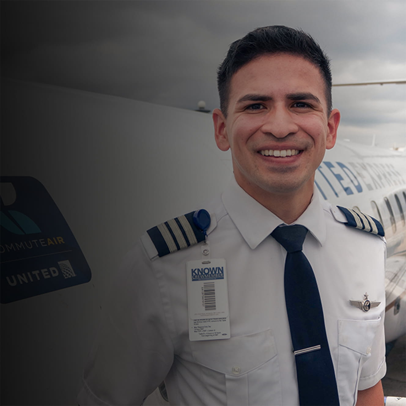 Pilot Juan Pena stands next to a plane.