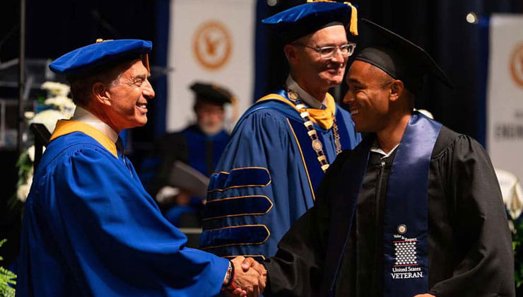 Graduate shaking hands at Commencement