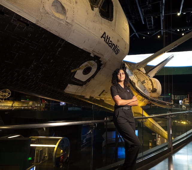 Student Liz Bosch standing in front of plane