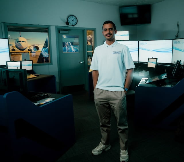 International student standing in ATC lab