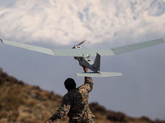 A man launches a UAS drone