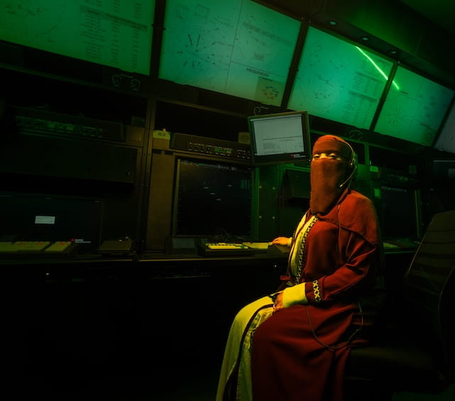 International student in front of several screens