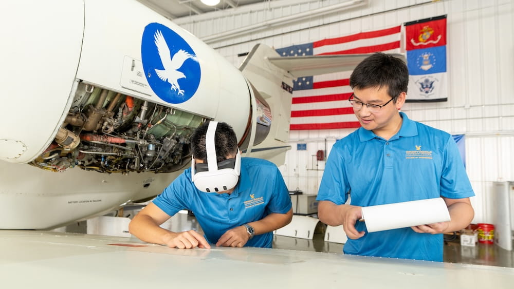 Two members from the NASA COE Team inside a hangar