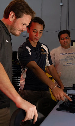 Students and professor working in the Robotics and Autonomous Systems Lab