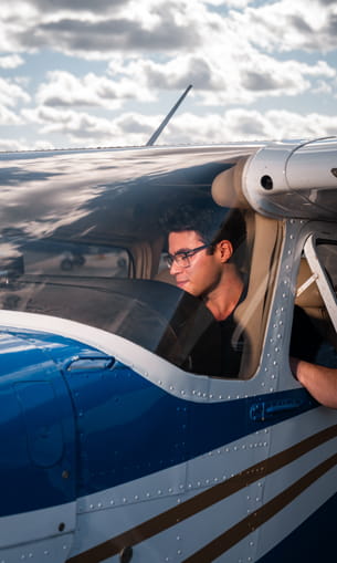 Man sits in a cockpit.