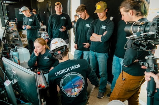 A team stands together in a laboratory setting.