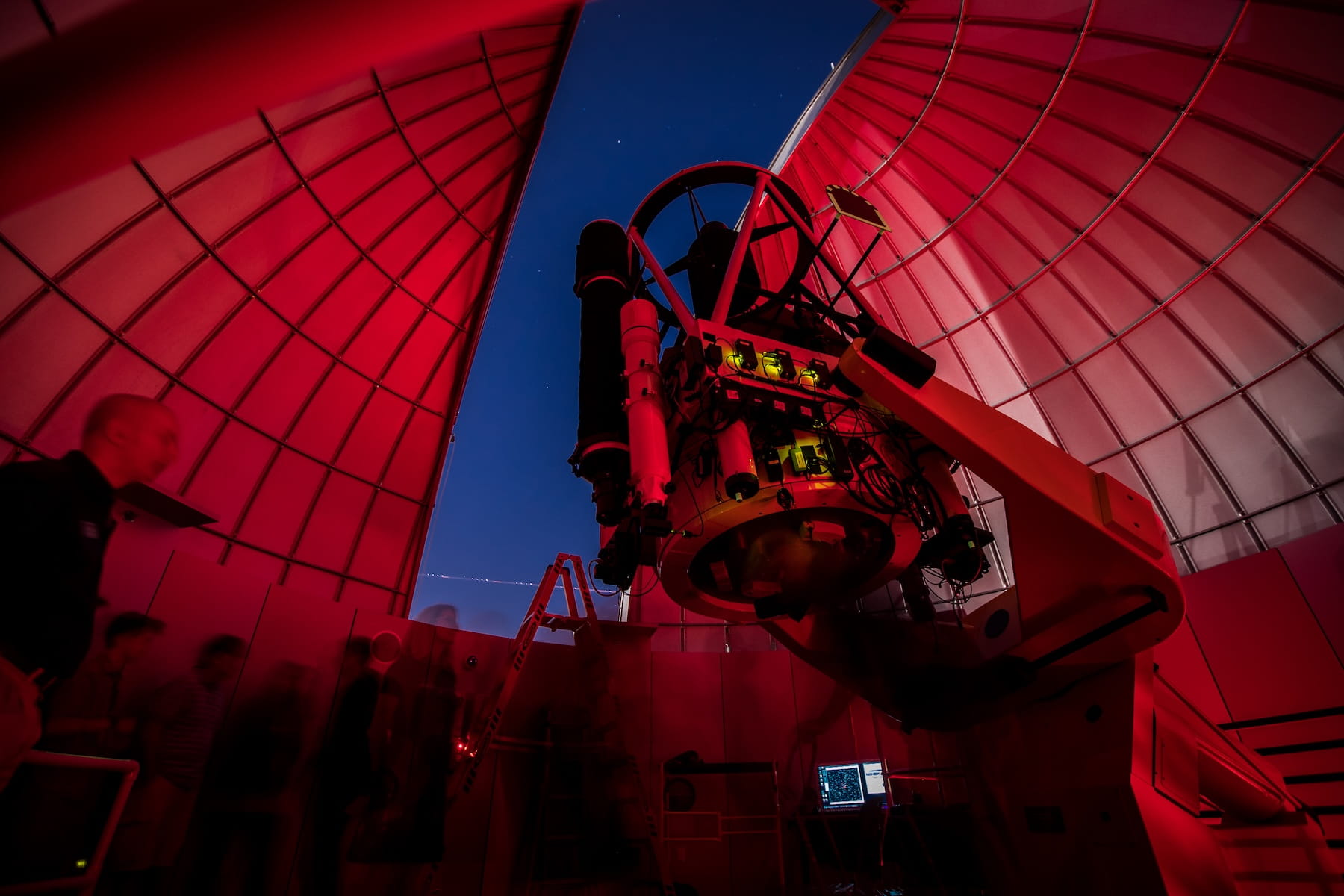 A person looking at equipment in an observatory.