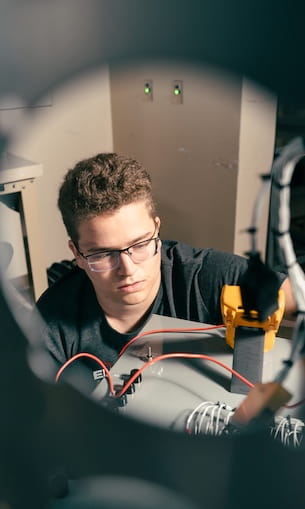 A student working in the avionics lab in AMS.