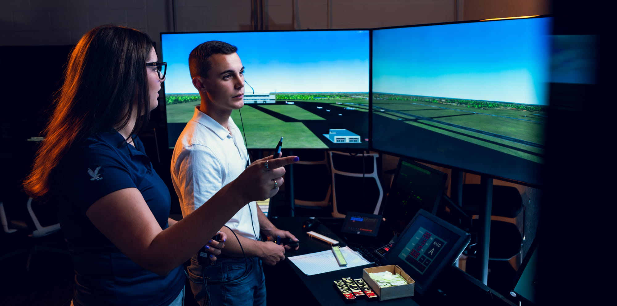 Two students work in the air traffic controller lab.