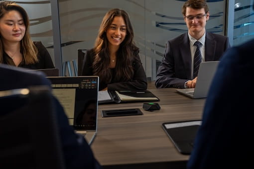 A group of business professionals sitting at a conference table.