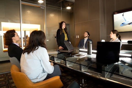 A group of business professionals sitting in a conference room having a meeting.