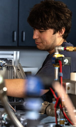 A person working on equipment in a laboratory setting.