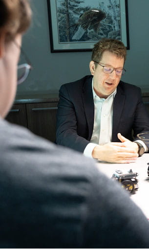 Two men in negotiations seated at a table.