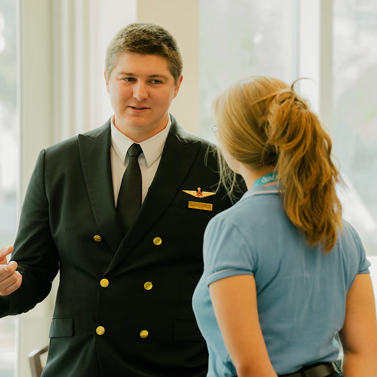 A pilot having a conversation with a woman