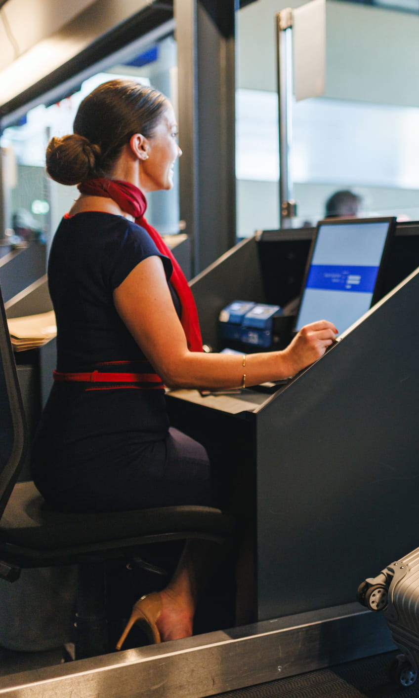 Airline worker checks in luggage.