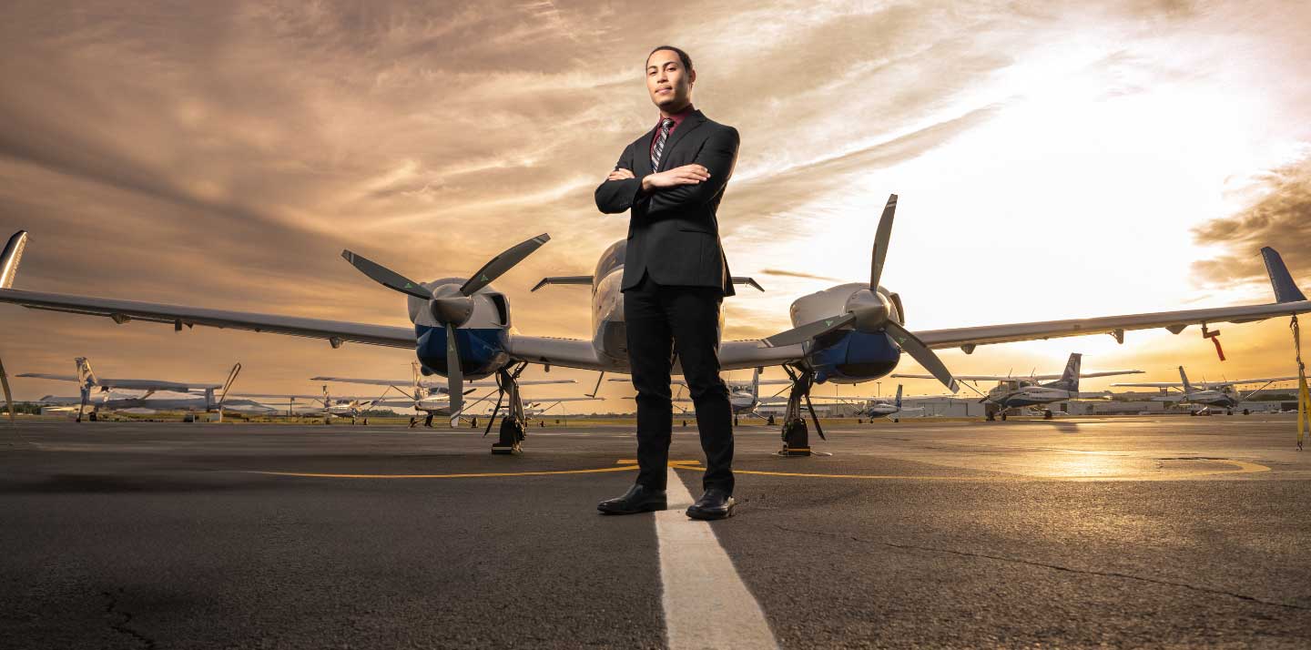 ISTAT Certificate hero image — student standing at flight line.