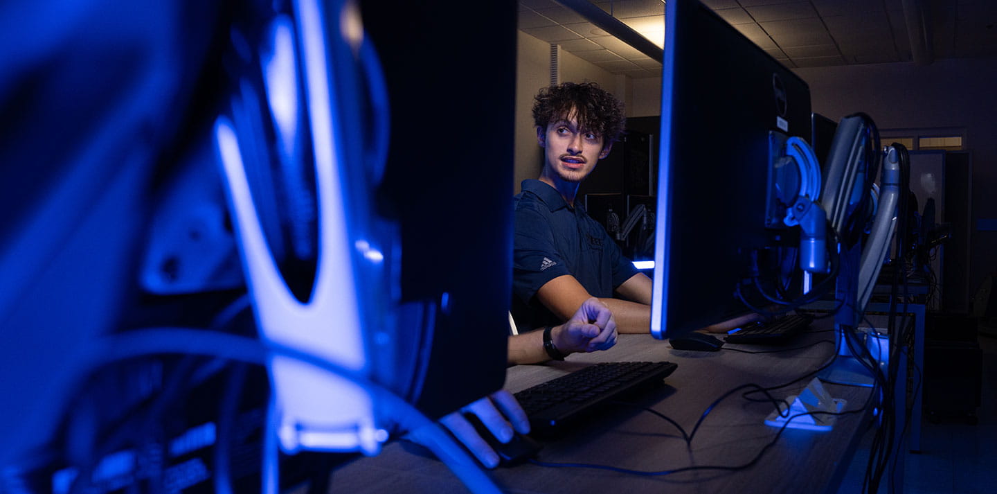 Students in front of computer monitors
