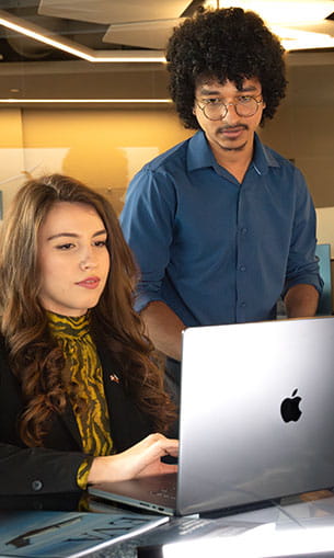 Students surrounding a laptop