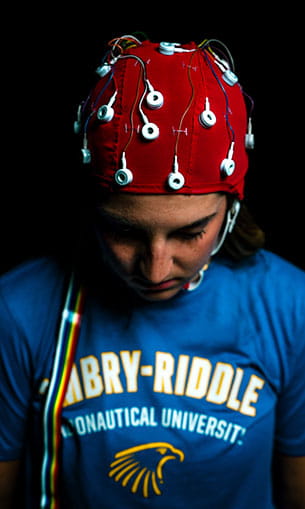 A person wearing a red helmet with lights