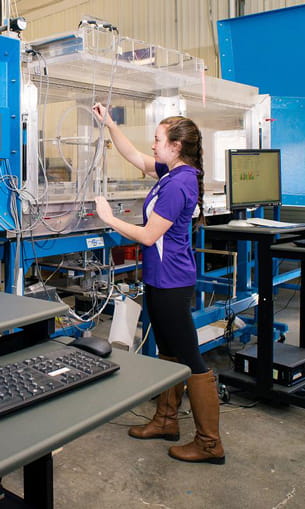 Student works with wind tunnel.