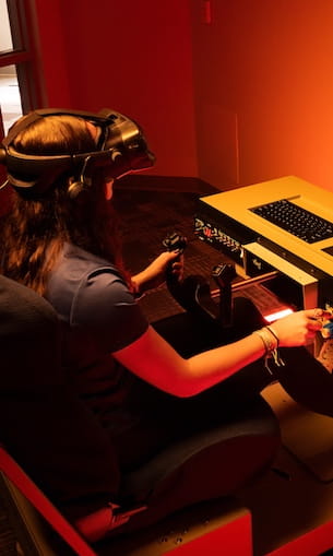 Student using flight simulator.