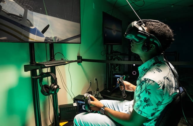Student using flight simulator.