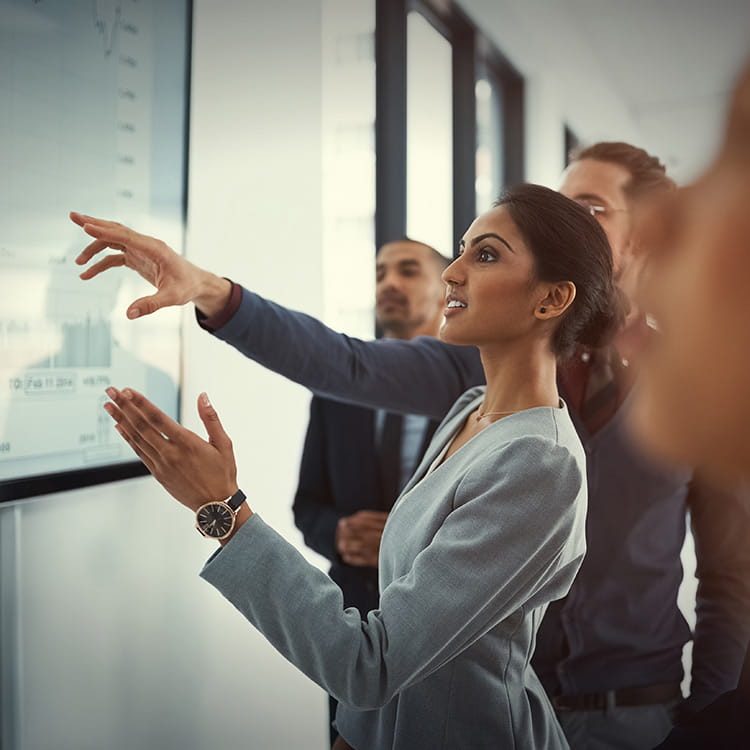 A businesswoman giving a presentation in a boardroom