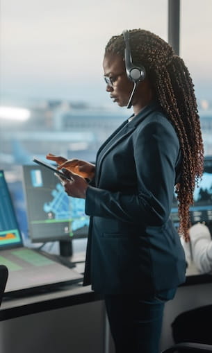 Air traffic controller looks at tablet.