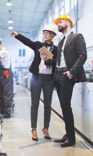 Two airline employees look at equipment.