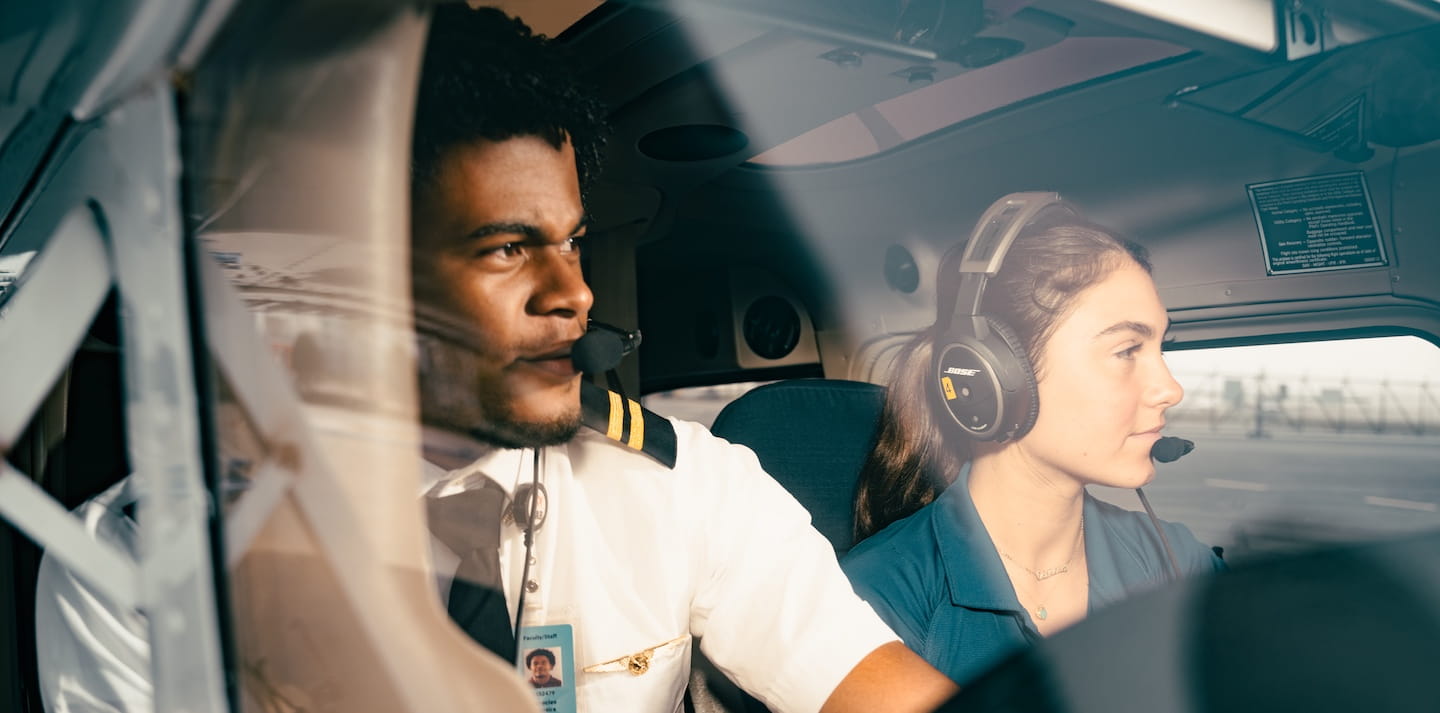Two air traffic controllers look at aircraft.