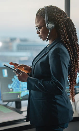 Air Traffic Controller holding tablet in Airport Tower
