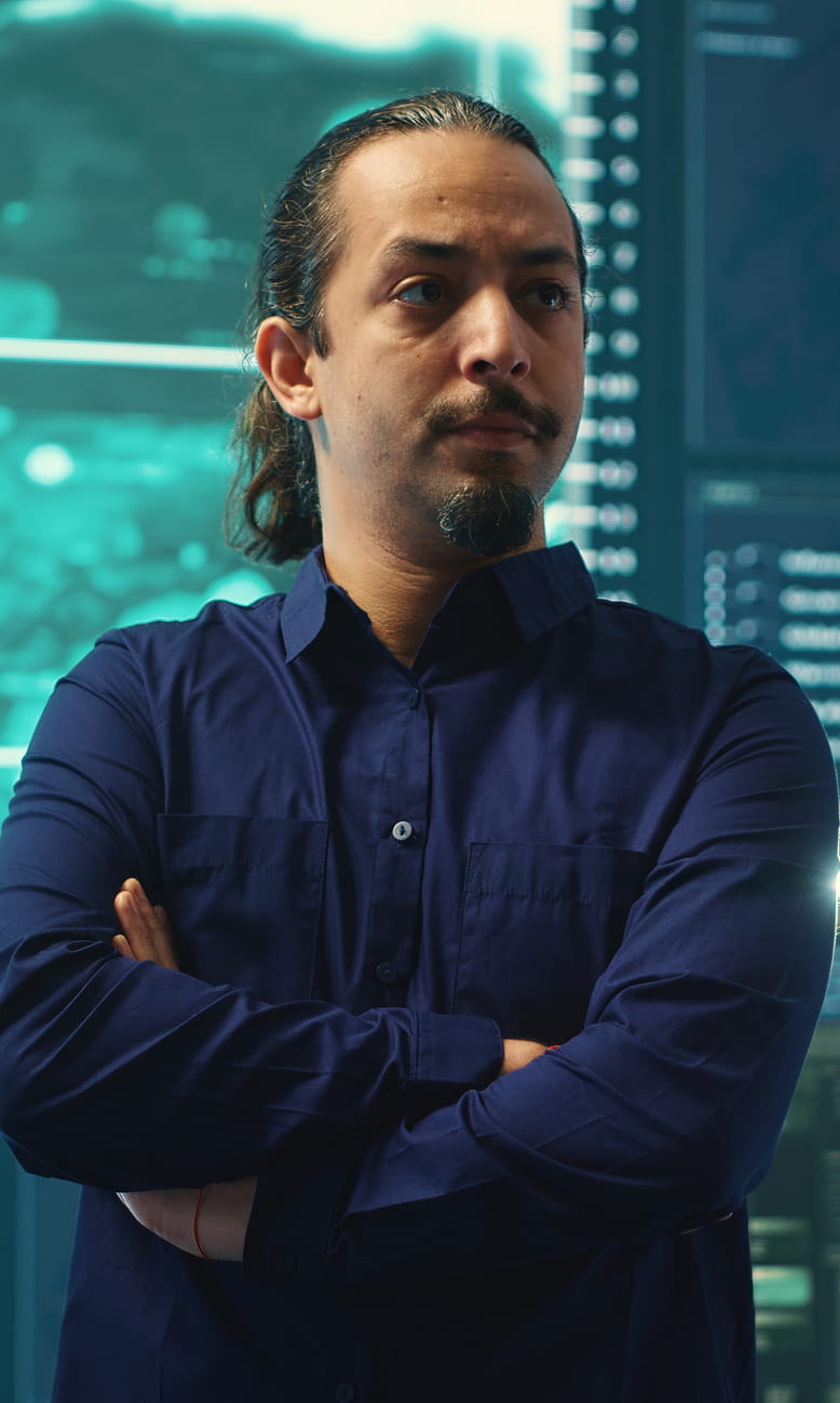 Man standing in a security room.
