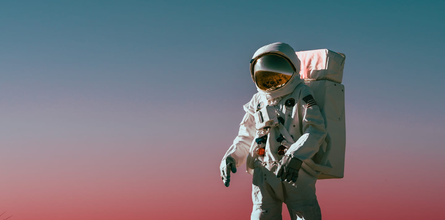 An astronaut in a spacesuit standing on the surface of a planet.