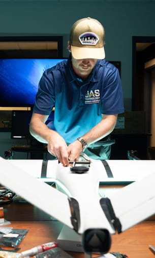 A person working on a drone in a laboratory setting.