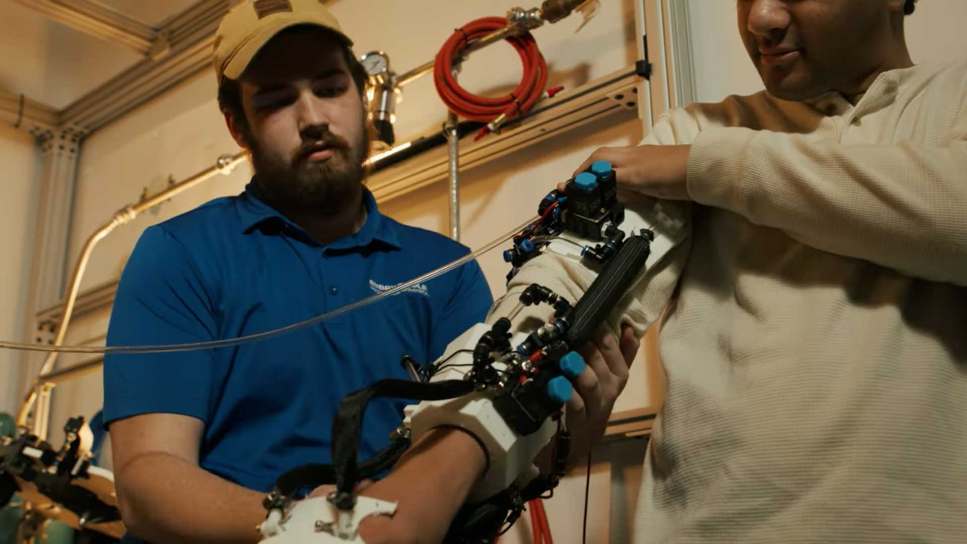 Student works on arm device.