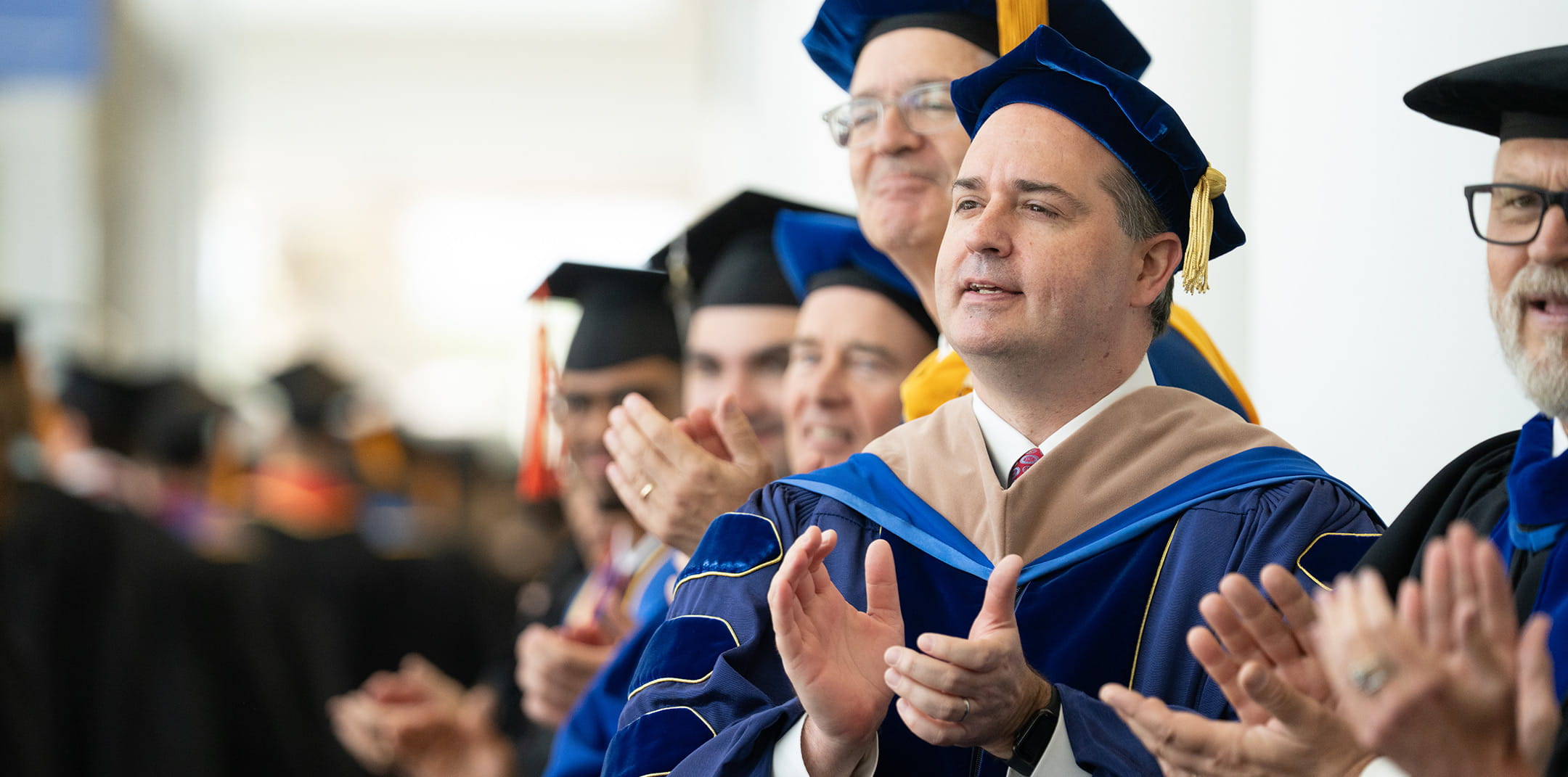 Faculty clapping at commencement
