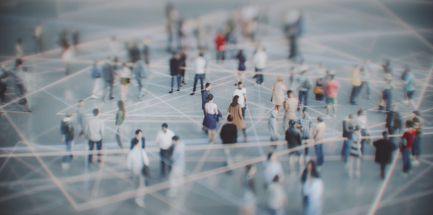 A overhead view of many people standing in scattered groups, connected by faint lines suggesting a network or web of connections.
