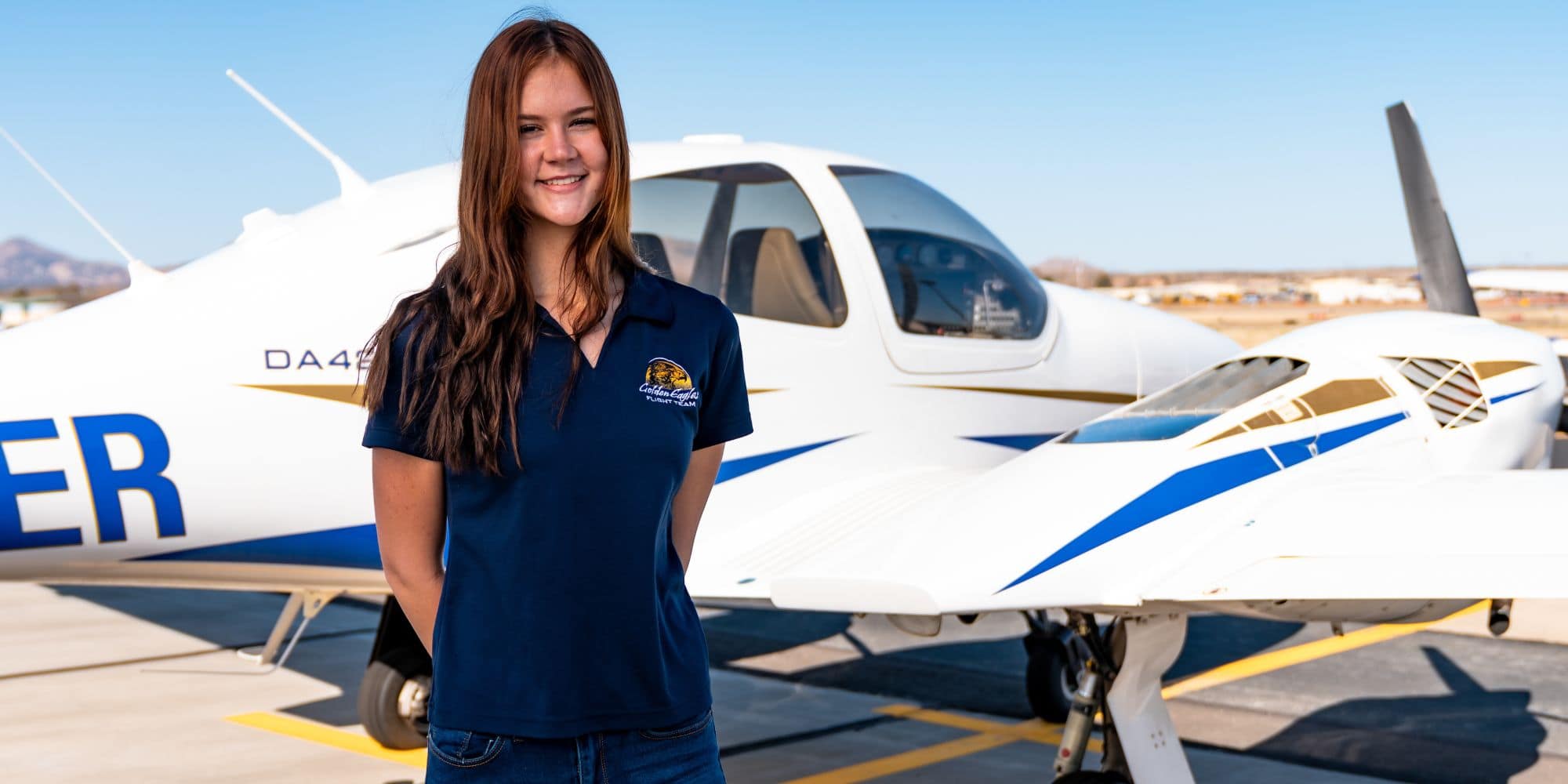 B.S. in Aeronautical Science student and Boeing Scholar Anna Scott beside an aircraft on the Prescott Flight Line. (Photo: Embry‑Riddle / Connor McShane)
