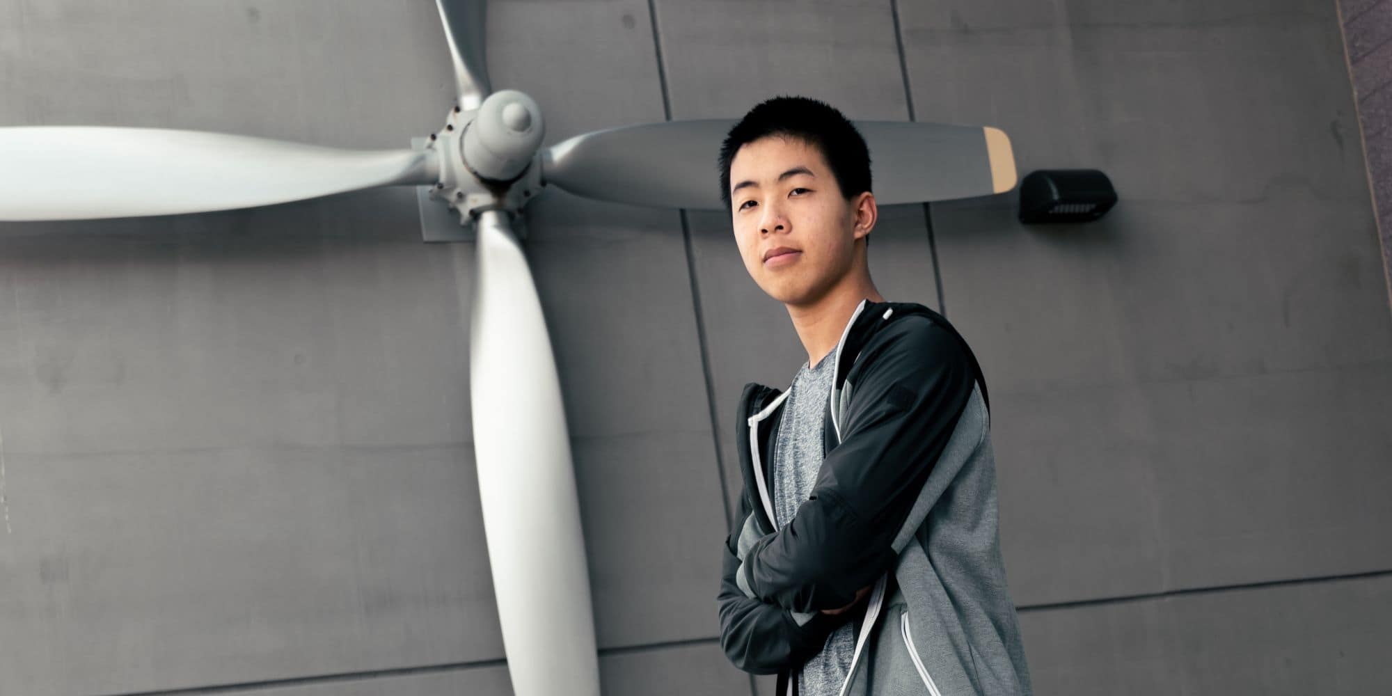 Aeronautical Science major Samuel Low ('25) standing in front of Prescott Campus' AXFAB Building. (Photo: Embry-Riddle / Connor McShane).