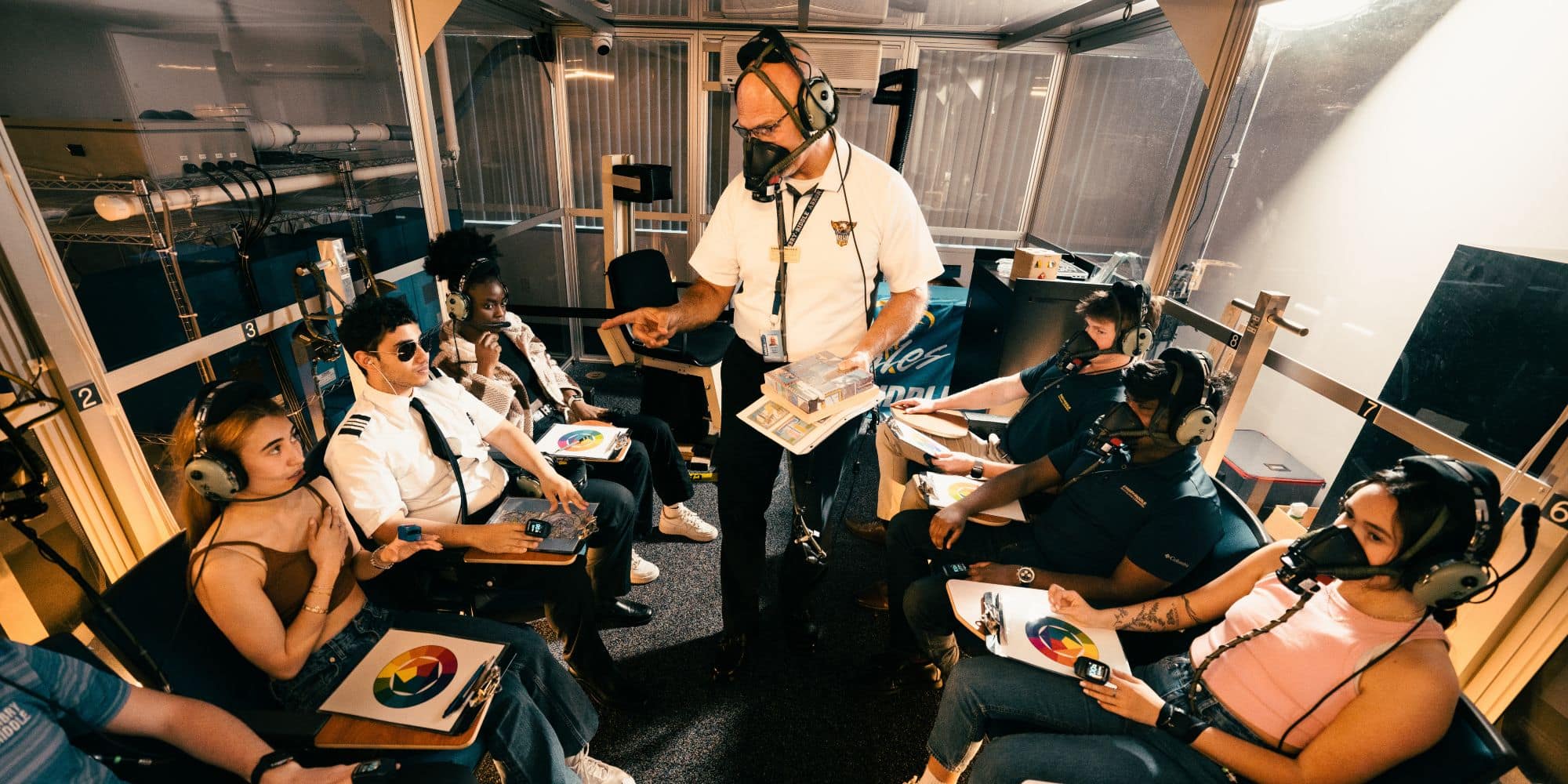 College of Aviation Professor Scott Wagner discusses a student’s reaction to the onset of hypoxia in Embry‑Riddle’s High-Altitude Chamber. (Photo: Embry‑Riddle / Bill Fredette-Huffman)