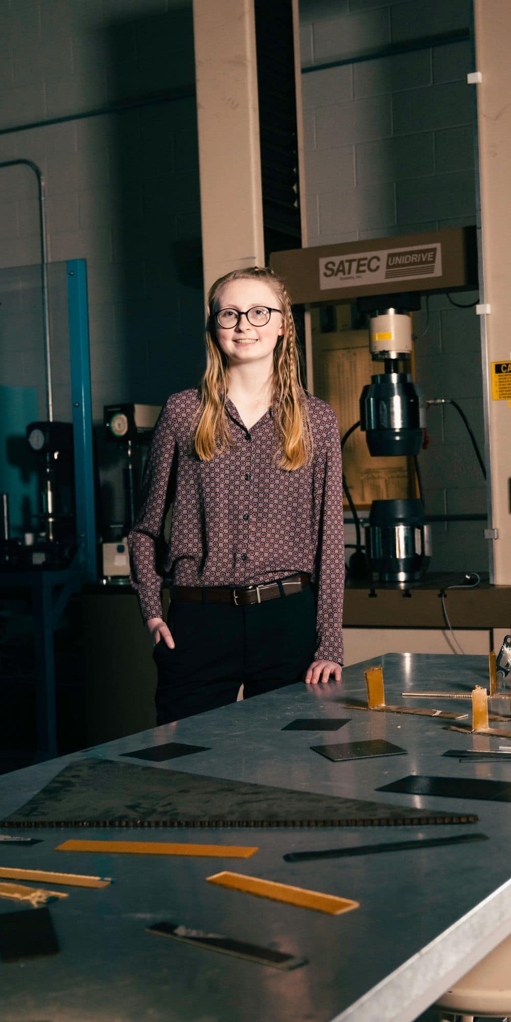 Alexis Hope Elmer (‘24) standing at a workbench in the materials lab on the Prescott Campus. (Photo: Embry-Riddle / Connor McShane)