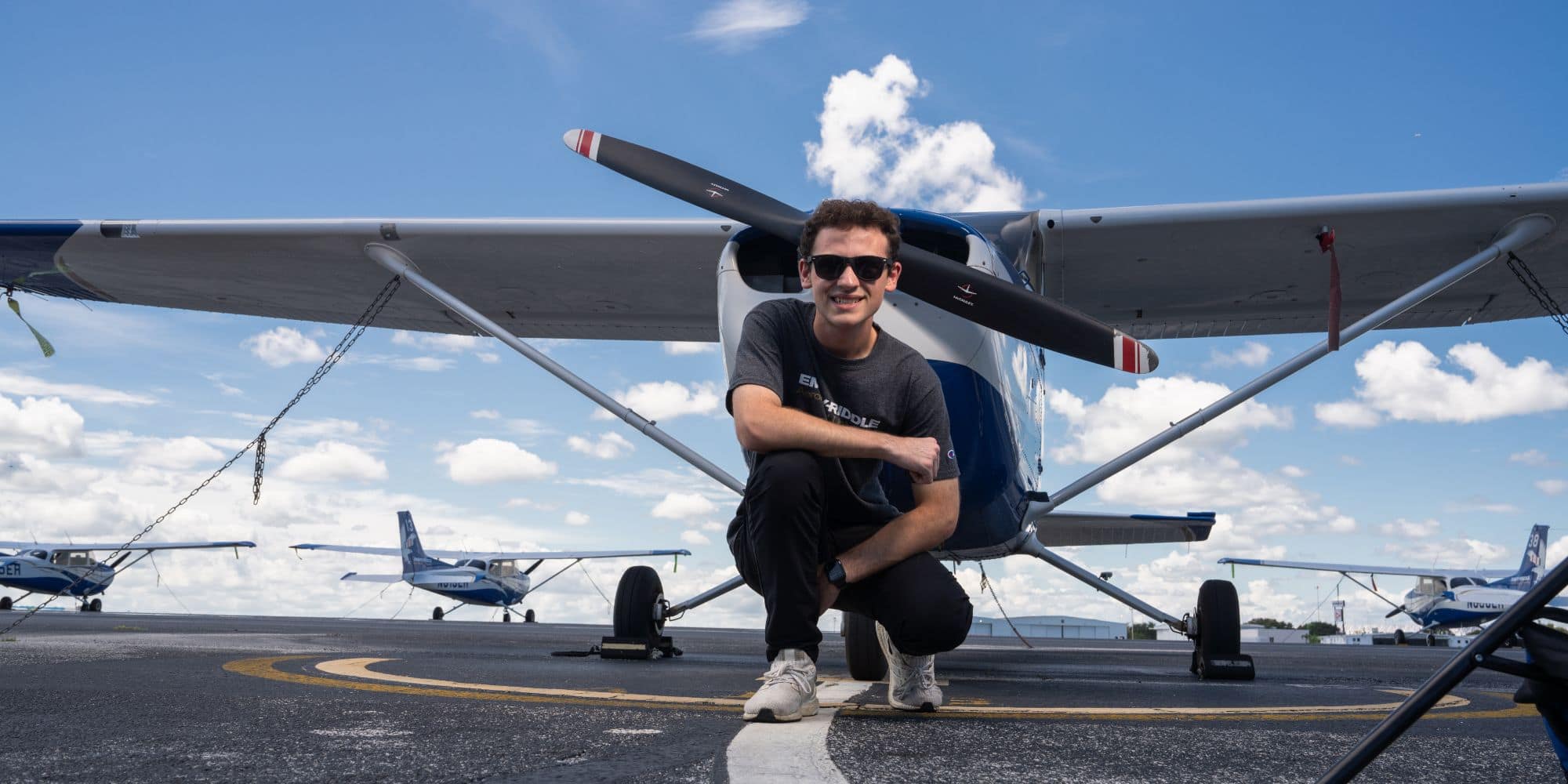 Hudson Garber with a plane from Embry-Riddle's fleet, on the Daytona Beach, Florida, campus. (Photo: Embry-Riddle/Bill Fredette-Huffman)