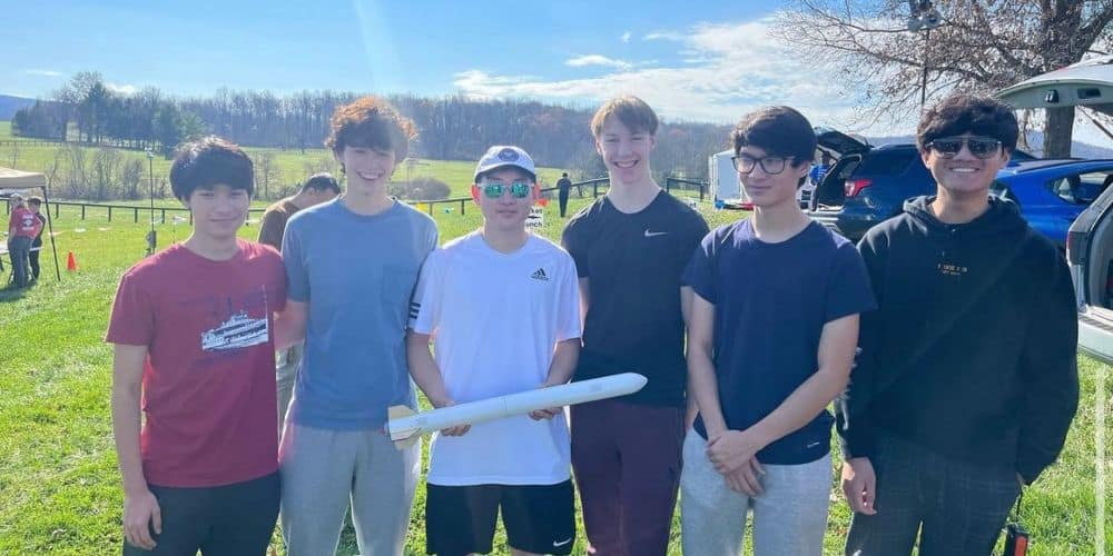 Ryan Shields (third from right) and teammates from the rocket club at Oakton High pose with one of their model rockets. (Photo: Ryan Shields)